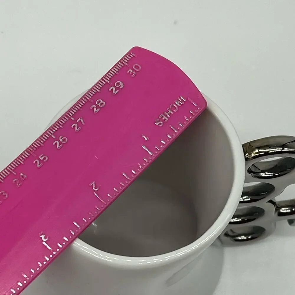Brass knuckles coffee mug white and silver